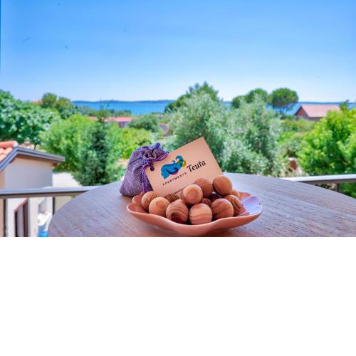 Teuta Apartments - a beach and a sea view